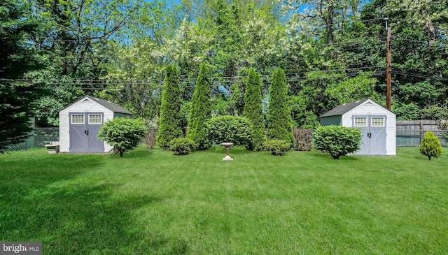 view of yard featuring a storage unit and an outbuilding