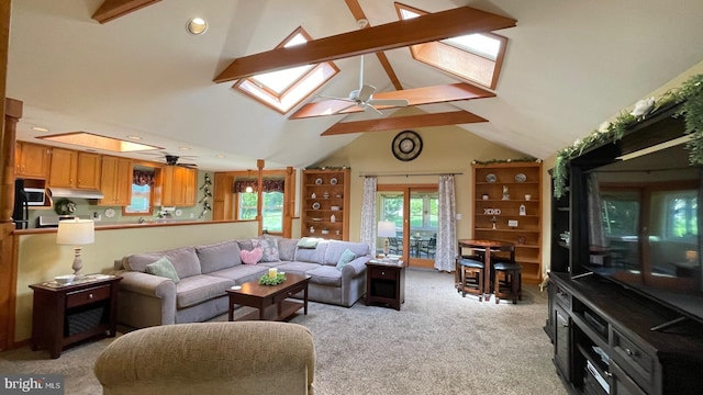 living room with a skylight, a ceiling fan, light carpet, healthy amount of natural light, and recessed lighting