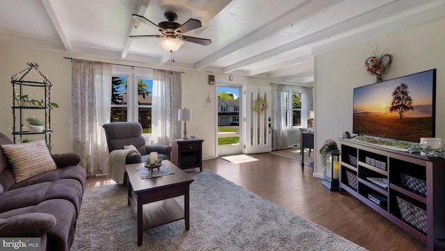 living room with wood finished floors, beamed ceiling, and a ceiling fan