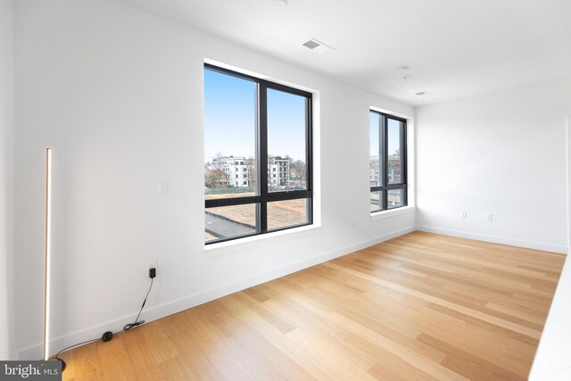 7175 12th St NW Unit 506, Washington, DC 20011 - unfurnished room with visible vents, baseboards, and wood finished floors