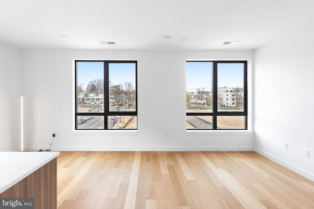 7175 12th St NW Unit 506, Washington, DC 20011 - unfurnished room featuring baseboards, light wood finished floors, and visible vents