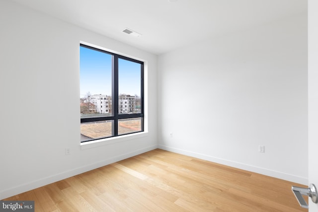 7175 12th St NW Unit 506, Washington, DC 20011 - spare room with baseboards, light wood-style flooring, and visible vents