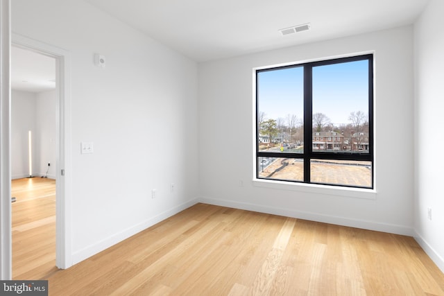 7175 12th St NW Unit 506, Washington, DC 20011 - spare room featuring visible vents, light wood finished floors, and baseboards