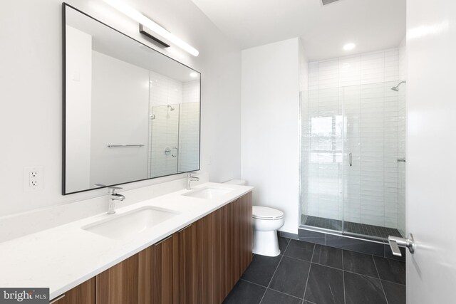 7175 12th St NW Unit 506, Washington, DC 20011 - bathroom featuring tile patterned flooring, a sink, toilet, and a shower stall