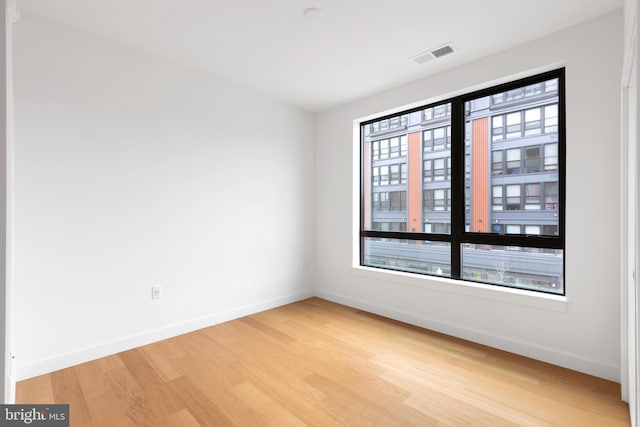 7175 12th St NW Unit 506, Washington, DC 20011 - empty room featuring baseboards, wood finished floors, and visible vents