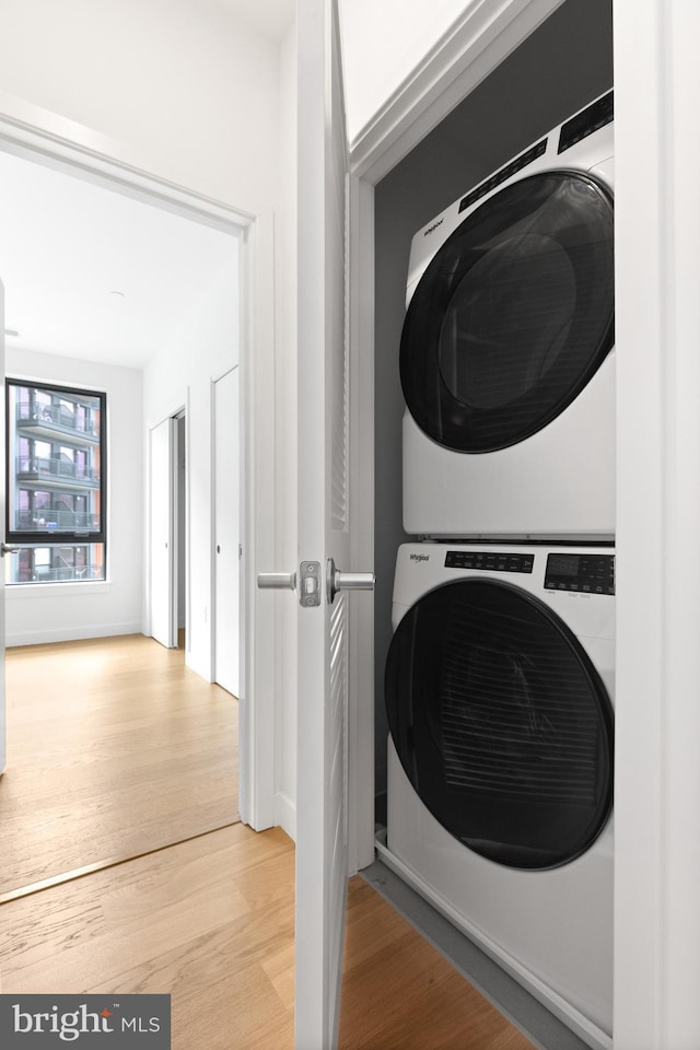 7175 12th St NW Unit 506, Washington, DC 20011 - laundry area with laundry area, wood finished floors, and stacked washer and clothes dryer