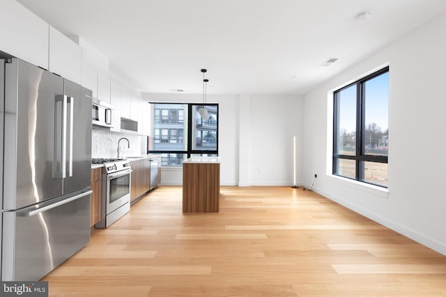 7175 12th St NW Unit 506, Washington, DC 20011 - kitchen with appliances with stainless steel finishes, a wealth of natural light, and a center island
