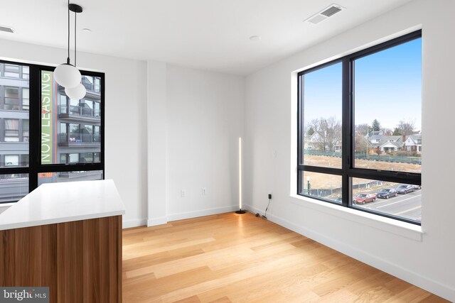 7175 12th St NW Unit 506, Washington, DC 20011 - unfurnished dining area with light wood-style floors, baseboards, and a wealth of natural light