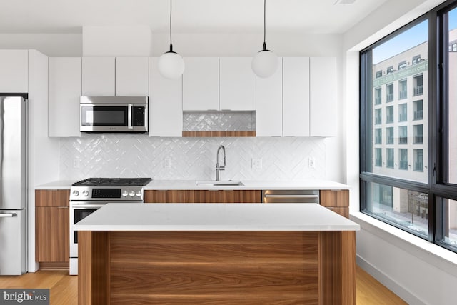 7175 12th St NW Unit 506, Washington, DC 20011 - kitchen featuring light countertops, appliances with stainless steel finishes, a sink, and modern cabinets