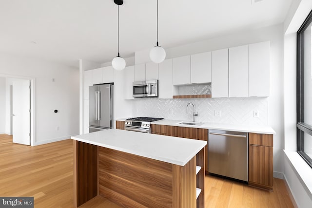 7175 12th St NW Unit 506, Washington, DC 20011 - kitchen with a sink, appliances with stainless steel finishes, open shelves, and light wood finished floors