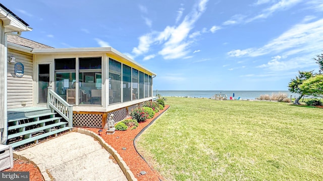 view of yard with a water view and a sunroom