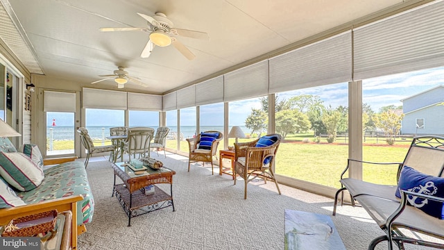 sunroom / solarium featuring ceiling fan, a wealth of natural light, and outdoor lounge area