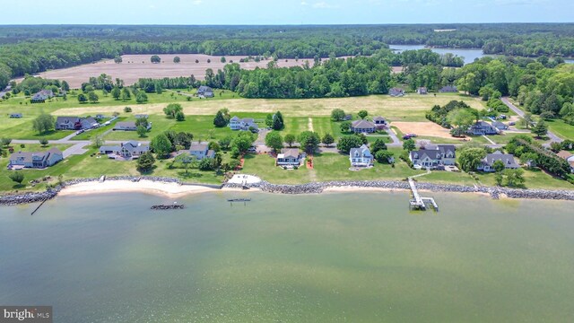 drone / aerial view with a view of trees and a water view