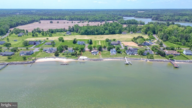 birds eye view of property with a water view and a view of trees