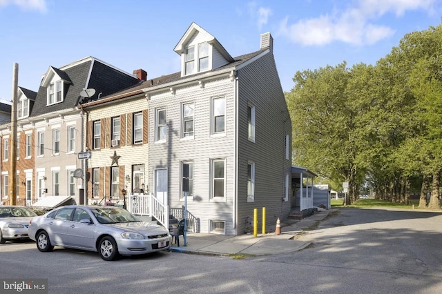 multi unit property featuring a chimney and entry steps