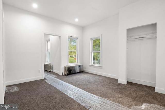 unfurnished bedroom with radiator, baseboards, carpet flooring, and recessed lighting