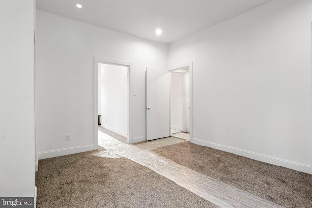 carpeted spare room with baseboards and recessed lighting