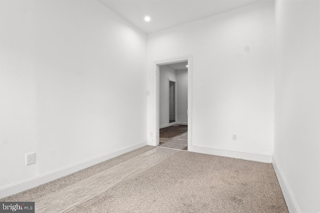 carpeted spare room with baseboards and recessed lighting