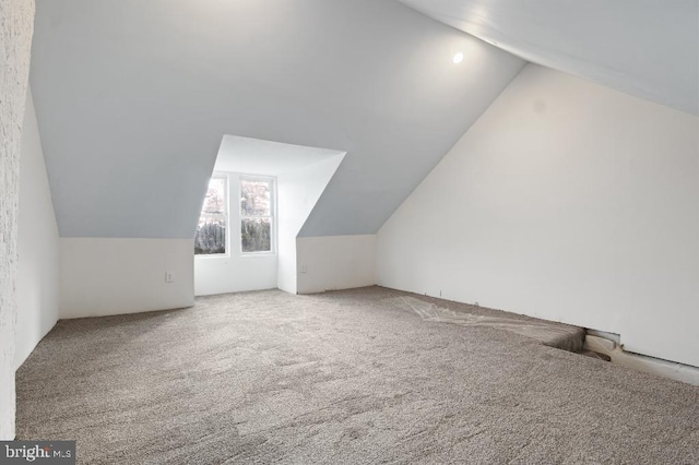 bonus room with carpet and lofted ceiling