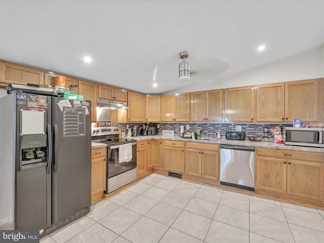 24 W Garibaldi Ave, Nesquehoning, PA 18240 - kitchen with backsplash, visible vents, appliances with stainless steel finishes, vaulted ceiling, and under cabinet range hood