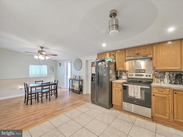 24 W Garibaldi Ave, Nesquehoning, PA 18240 - kitchen featuring stainless steel range with electric stovetop, black refrigerator with ice dispenser, recessed lighting, tasteful backsplash, and under cabinet range hood