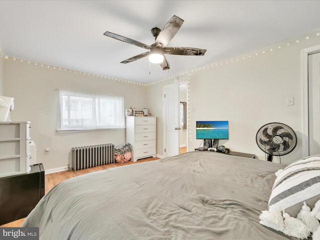 24 W Garibaldi Ave, Nesquehoning, PA 18240 - bedroom with radiator heating unit, baseboards, a ceiling fan, and wood finished floors