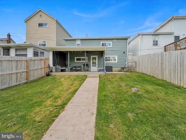 24 W Garibaldi Ave, Nesquehoning, PA 18240 - rear view of property featuring a fenced backyard, a patio area, and a yard