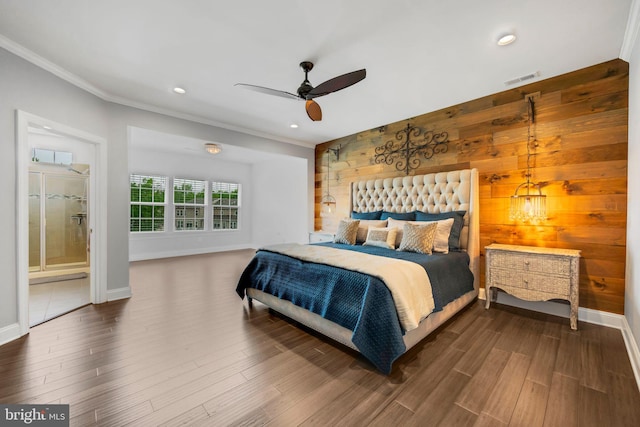 bedroom featuring crown molding, wood finished floors, wooden walls, and baseboards