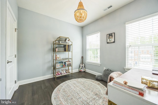 office area featuring visible vents, wood finished floors, baseboards, and a notable chandelier