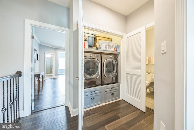 washroom with laundry area, baseboards, dark wood-type flooring, and washer and dryer