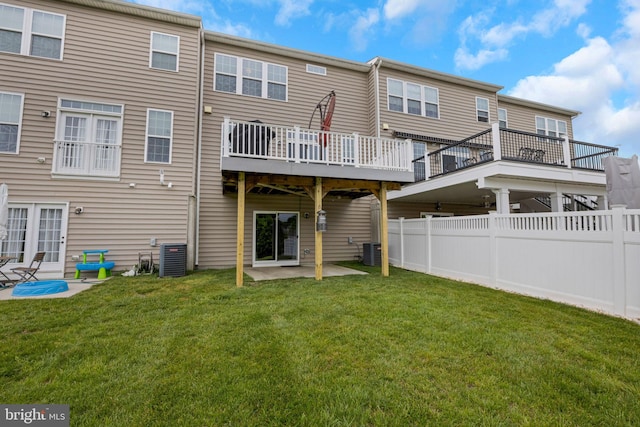 back of property with a lawn, a patio area, cooling unit, and fence