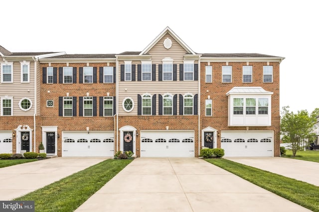 view of property with driveway, brick siding, and a garage
