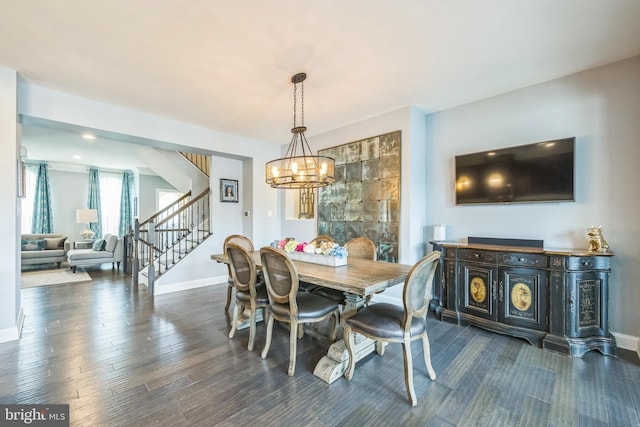 dining room with stairway, a chandelier, baseboards, and wood finished floors