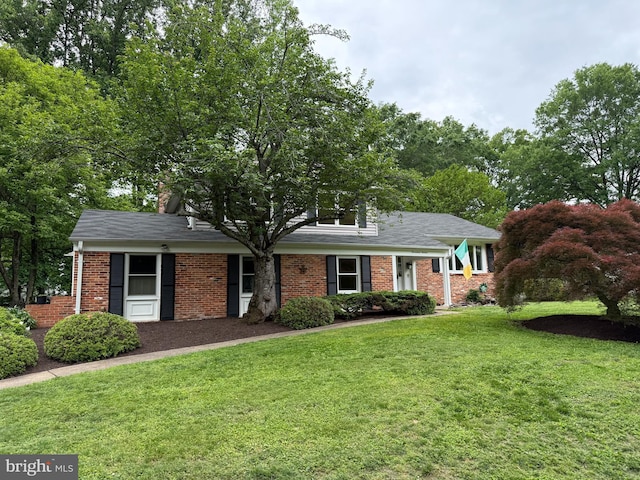 1716 Saddle Ridge Ct, Vienna, VA 22182 - view of front of property with a front lawn, brick siding, and a chimney