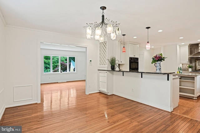 1716 Saddle Ridge Ct, Vienna, VA 22182 - kitchen with oven, light wood-style floors, white cabinetry, a chandelier, and backsplash