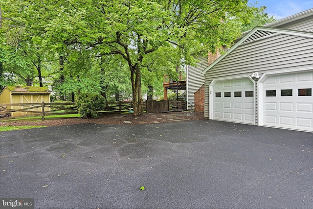 1716 Saddle Ridge Ct, Vienna, VA 22182 - view of side of home with driveway, fence, and an attached garage