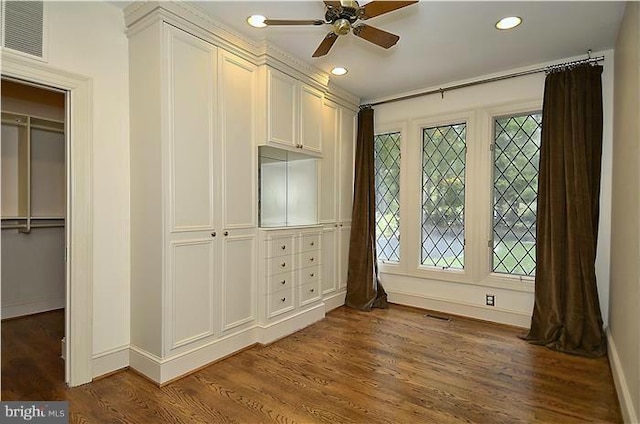 interior space with visible vents, baseboards, dark wood-style flooring, and a wealth of natural light