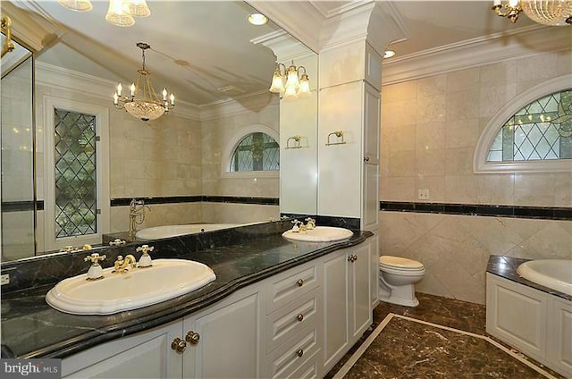 bathroom with a sink, tile walls, and a notable chandelier