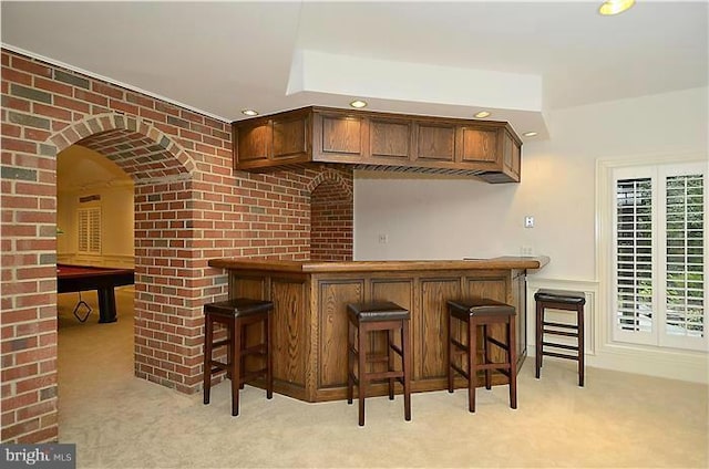 bar featuring light colored carpet, recessed lighting, arched walkways, pool table, and a dry bar