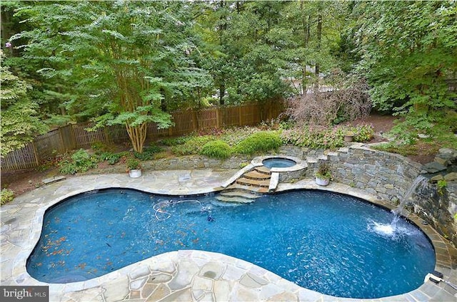 view of swimming pool with a fenced backyard, a fenced in pool, a patio, and an in ground hot tub