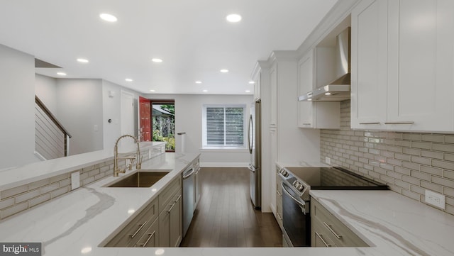 39 Oakmont Pl, Media, PA 19063 - kitchen featuring wall chimney range hood, appliances with stainless steel finishes, a sink, light stone counters, and dark wood-style floors