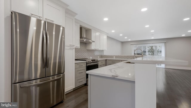 39 Oakmont Pl, Media, PA 19063 - kitchen with a peninsula, dark wood-type flooring, wall chimney exhaust hood, a sink, and stainless steel appliances
