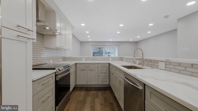 39 Oakmont Pl, Media, PA 19063 - kitchen with wall chimney range hood, appliances with stainless steel finishes, tasteful backsplash, and dark wood-type flooring