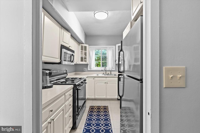 3128 Martha Custis Dr, Alexandria, VA 22302 - kitchen featuring stainless steel appliances, a sink, light countertops, light tile patterned floors, and a textured wall