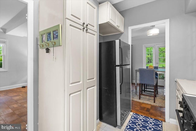 3128 Martha Custis Dr, Alexandria, VA 22302 - kitchen with freestanding refrigerator, white cabinetry, baseboards, stove, and french doors