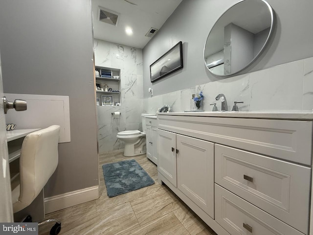 bathroom with visible vents, tile walls, toilet, and vanity