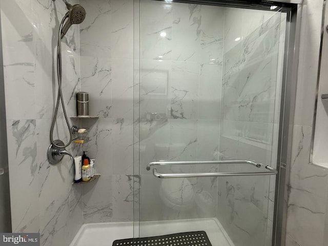 full bath with a marble finish shower