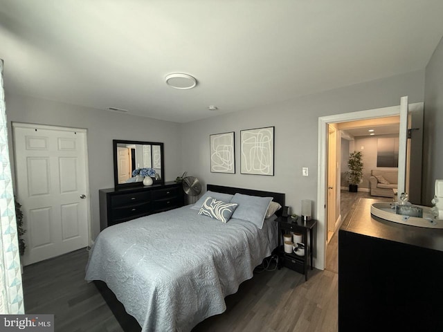 bedroom featuring wood finished floors and visible vents