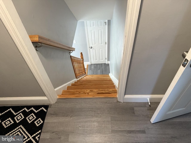 stairs with baseboards and wood finished floors