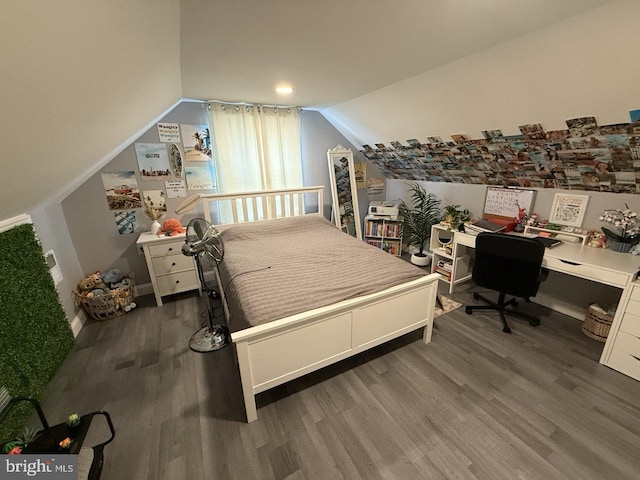 bedroom featuring wood finished floors and vaulted ceiling